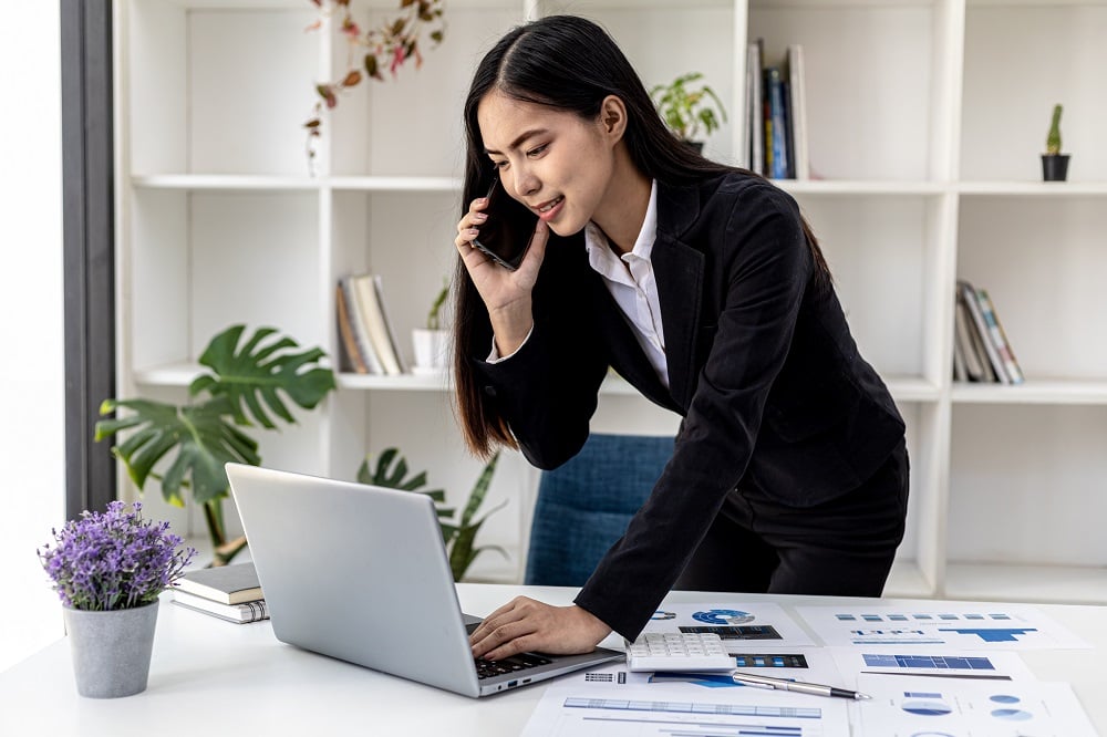 Asian woman talking on the phone, she is a salesperson in a star