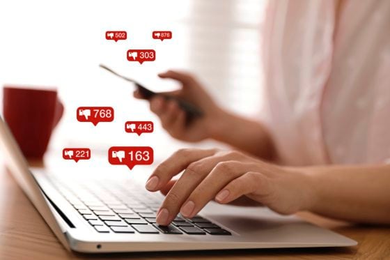 Woman working with laptop in office, closeup