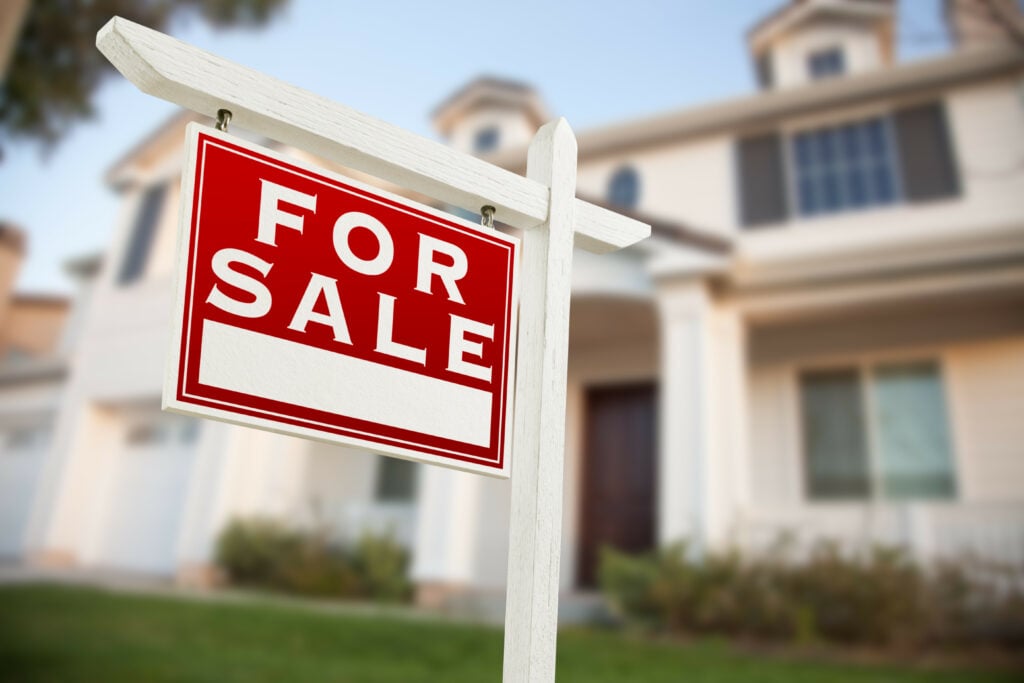 Home For Sale Real Estate Sign in Front of New House.