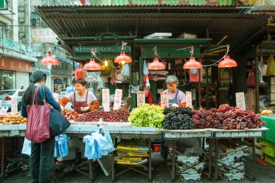 Woman Buying Vegetables In The Street Market, Hong Kong, February 17, 2014.