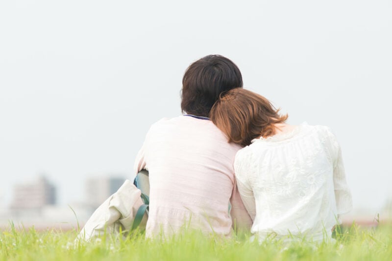 Men And Women Sit Down Snuggle Up Lawn