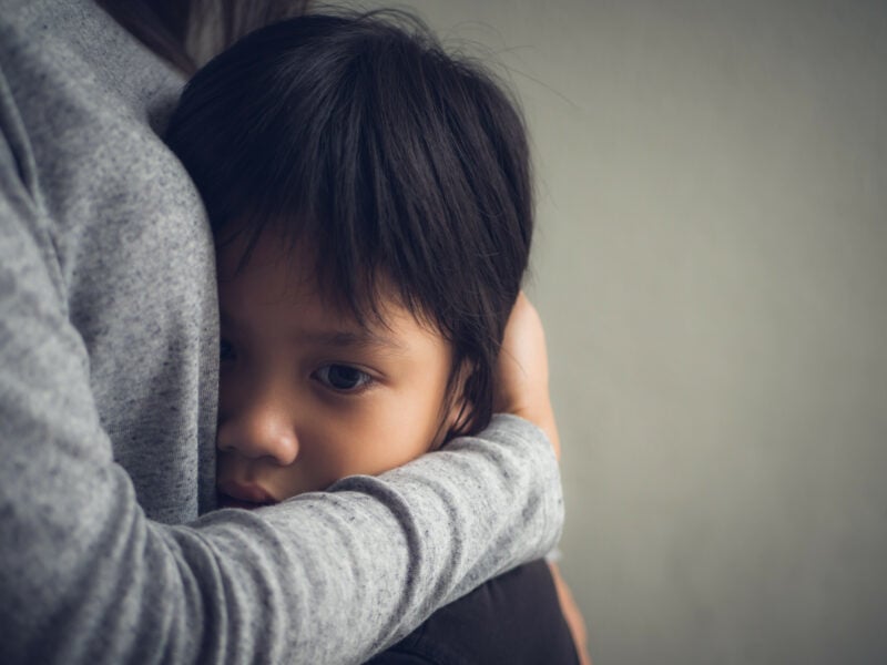 Closeup Sad Little Boy Being Hugged By His Mother At Home. Paren