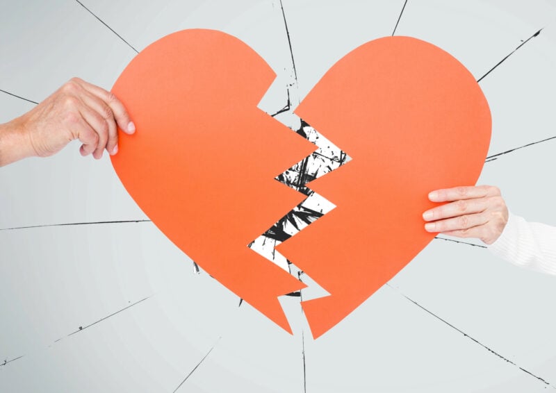 Hand Of Couple Holding Broken Hearts