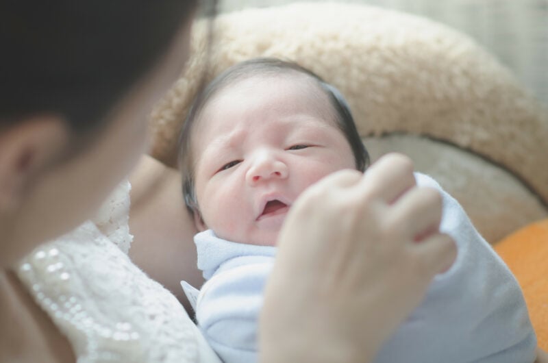 Mother Is Holding Her Sleeping Newborn Baby