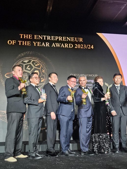 Frank (4th from left) on stage with the other winners after receiving his trophy.