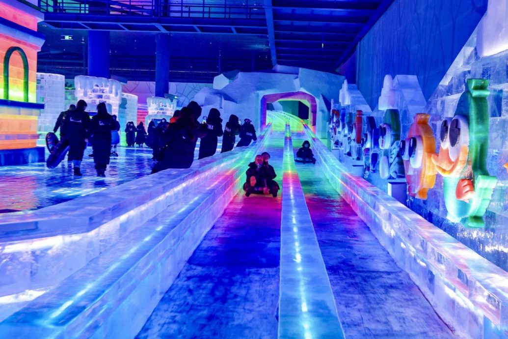 Visitors have fun at an indoor ice and snow theme park in Harbin, northeast China