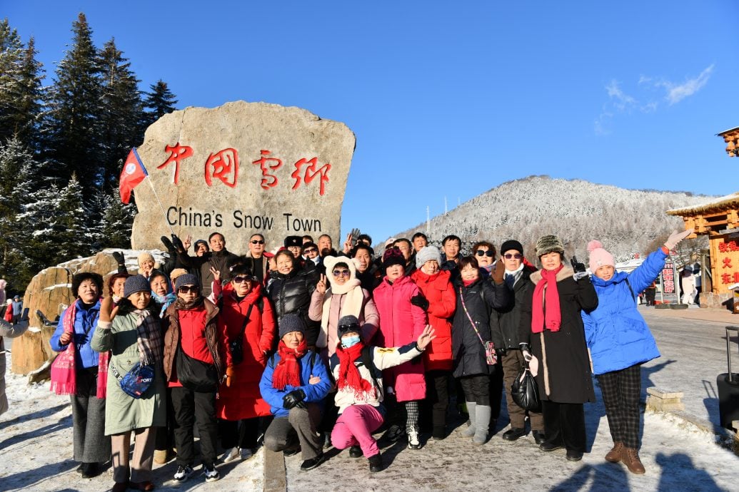 Tourists take a group photo in the 