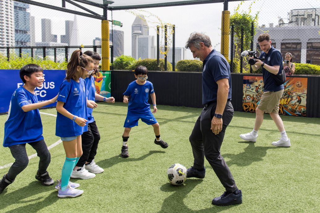 Chelsea Football Club legend Gianfranco Zola enjoying a friendly game with young beneficiaries from the Singapore Disability Sports Council on Saturday, 30 November, at the rooftop futsal court in Funan. The football coaching clinic was part of The Famous CFC, Chelsea’s flagship international fan engagement event presented by The Ascott Limited (Ascott), underscoring both organisations